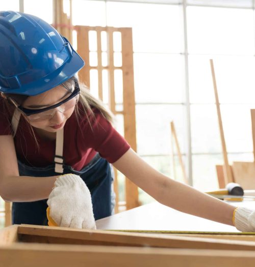 asian woman carpenter working and building furniture at wood workshop. asian joiner woman making furniture at furniture workshop